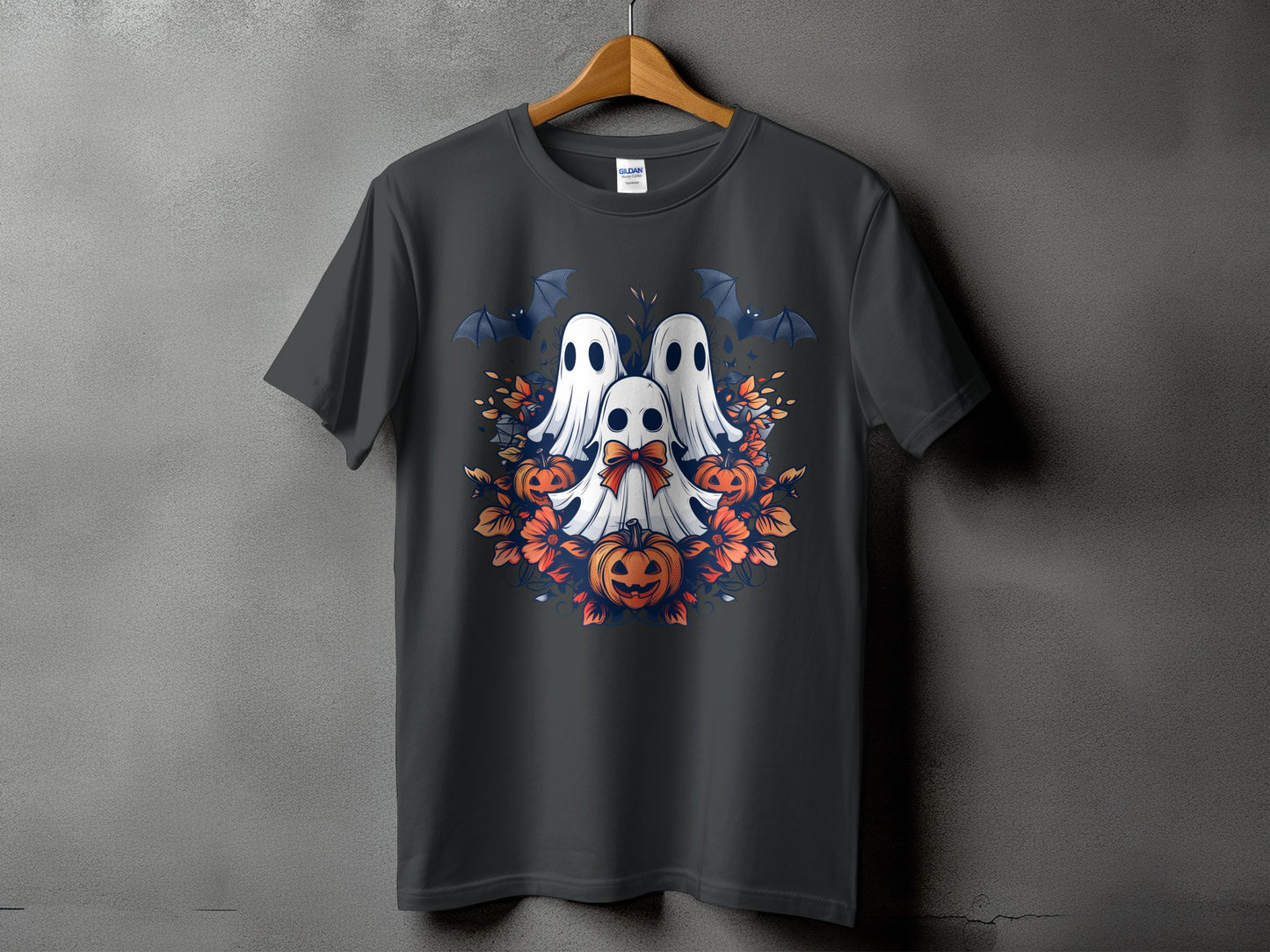 Three ghosts, bats, pumpkins, and orange flowers on a dark t-shirt.