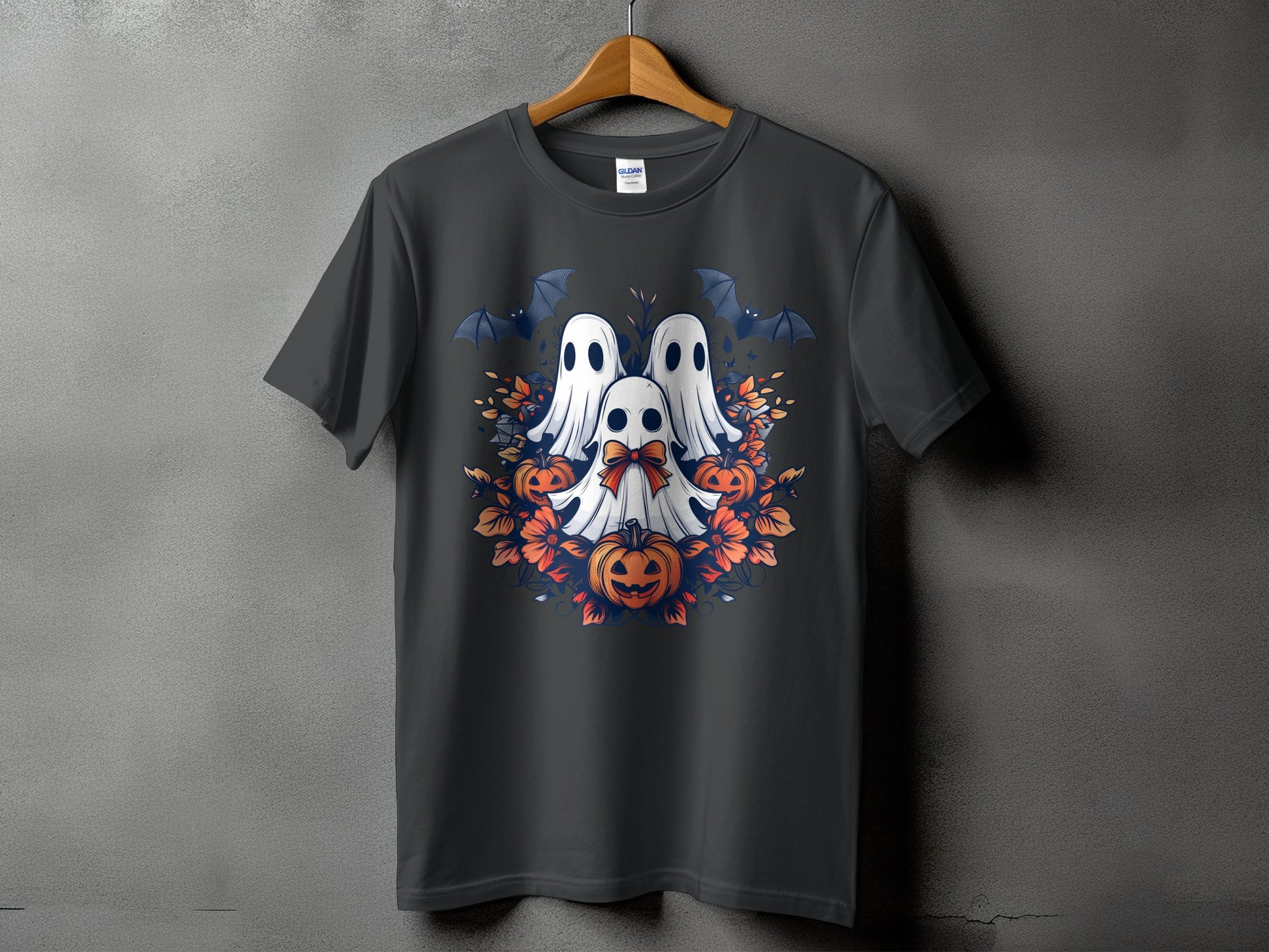 Three ghosts, bats, pumpkins, and orange flowers on a dark t-shirt.