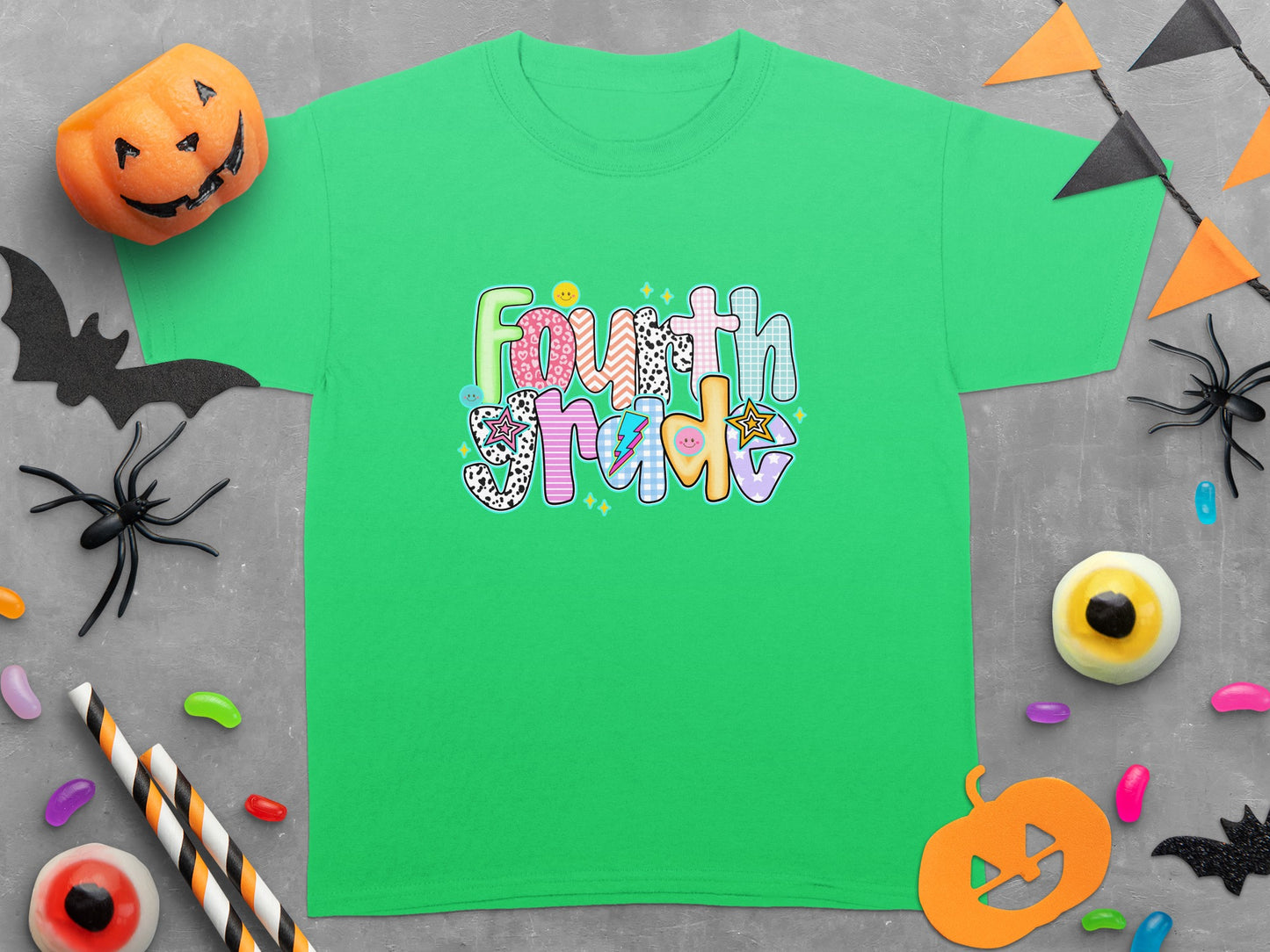 Green t-shirt with "Fourth Grade" text in colorful, patterned letters.