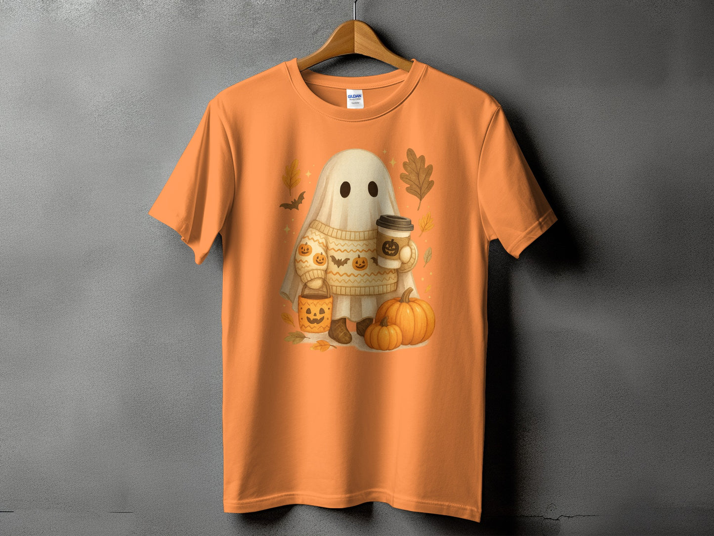 Orange t-shirt with a cute ghost holding a coffee cup and a pumpkin bucket.