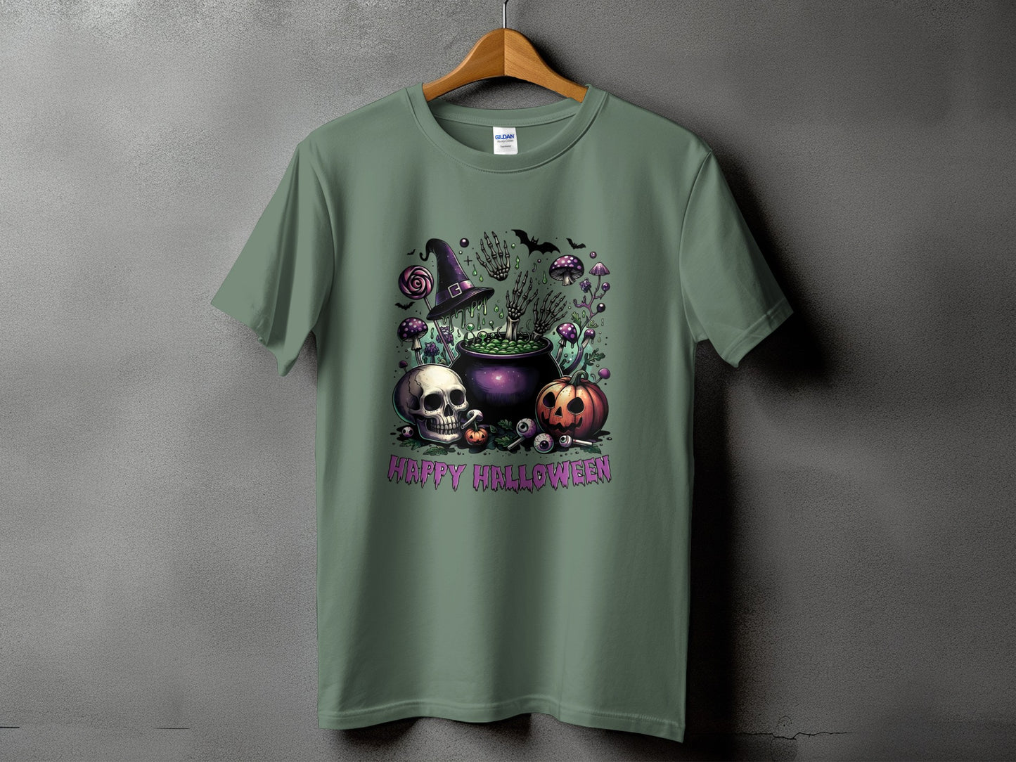 Green t-shirt with Halloween graphic: skull, pumpkin, cauldron, witch hat, and bats.