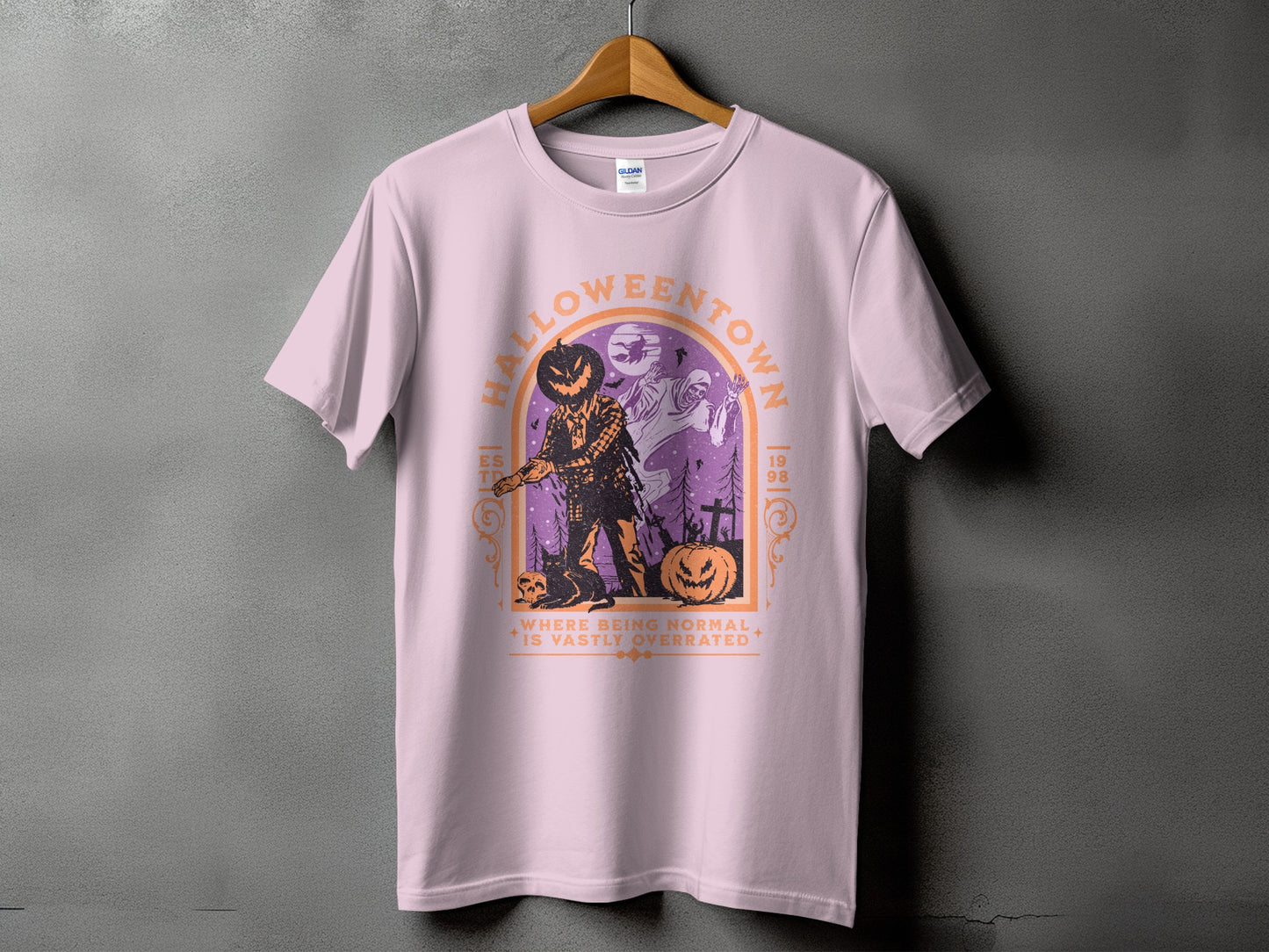 Light pink t-shirt with "HALLOWEENTOWN" graphic featuring a scarecrow and ghosts.