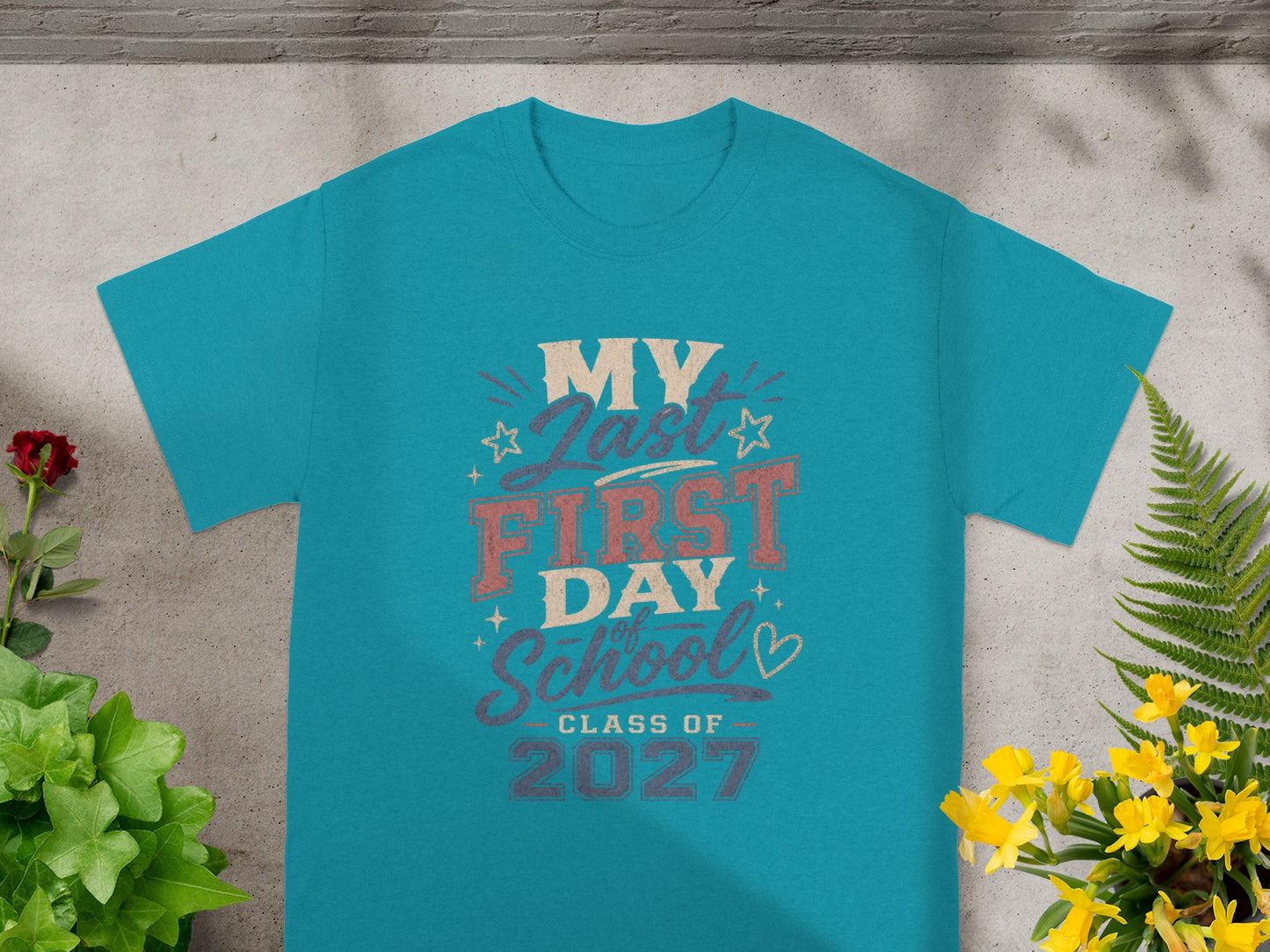 Teal t-shirt with faded text: My Last First Day, School, Class of 2027.