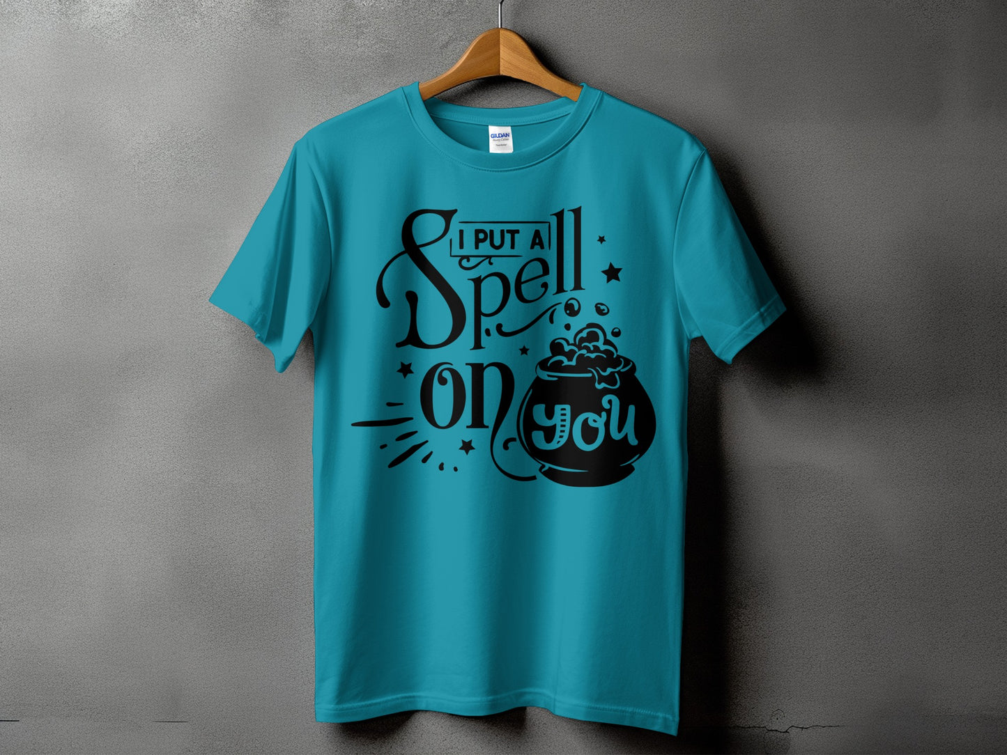 Teal t-shirt with "I Put A Spell On You" text and cauldron graphic.
