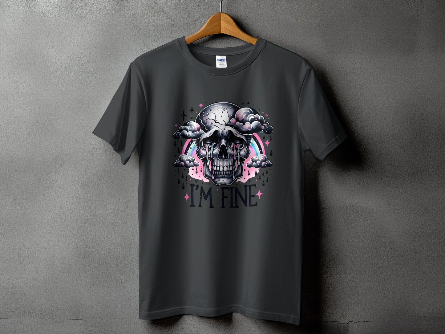 Dark grey t-shirt featuring a skull crying amidst clouds, with a rainbow and the text "I'M FINE".