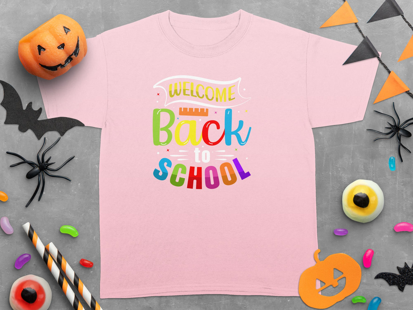 Pink t-shirt with "Welcome Back to School" text and Halloween decorations.