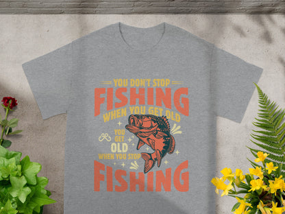 Grey t-shirt with "You don't stop fishing when you get old" text and fish graphic.