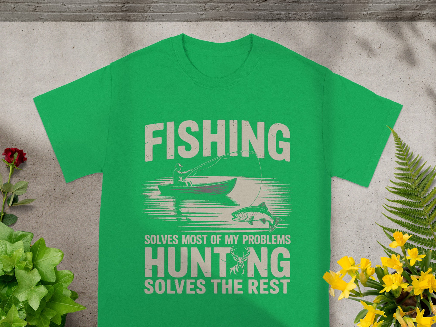Green t-shirt with fishing and hunting graphic and text.