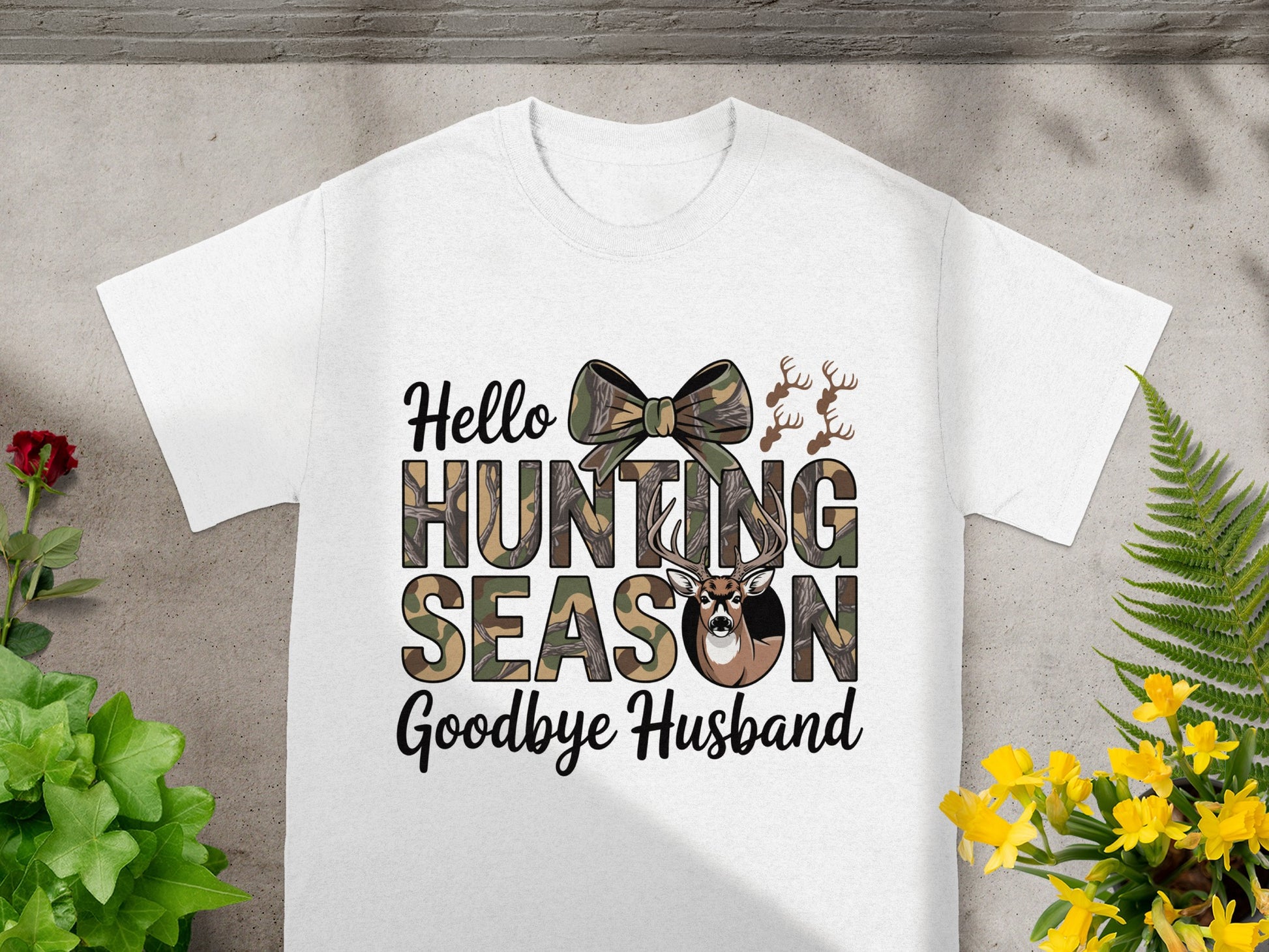 White t-shirt with "Hello Hunting Season Goodbye Husband" in camouflage text.