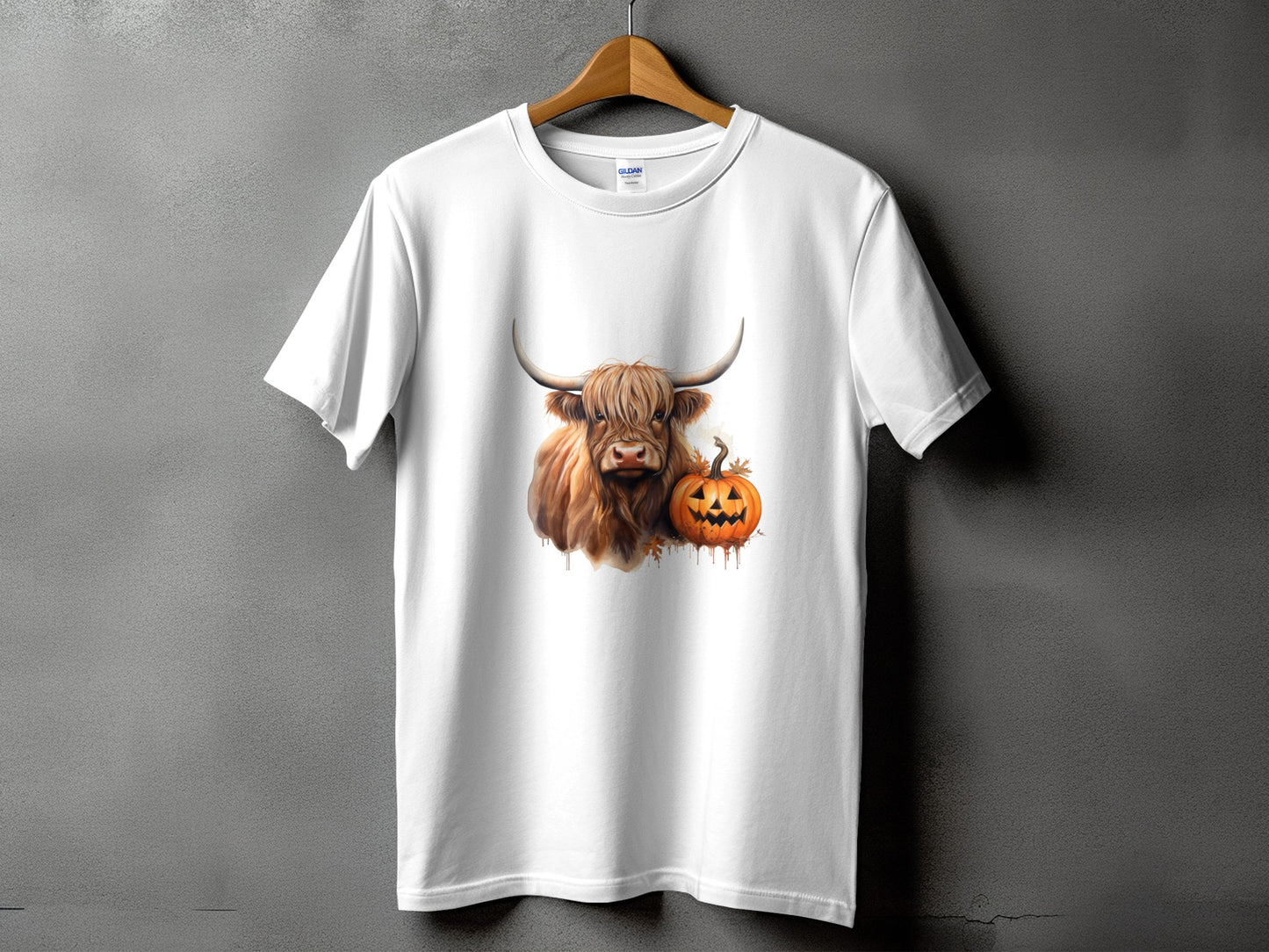 White t-shirt with Highland cow and jack-o'-lantern graphic for Halloween.