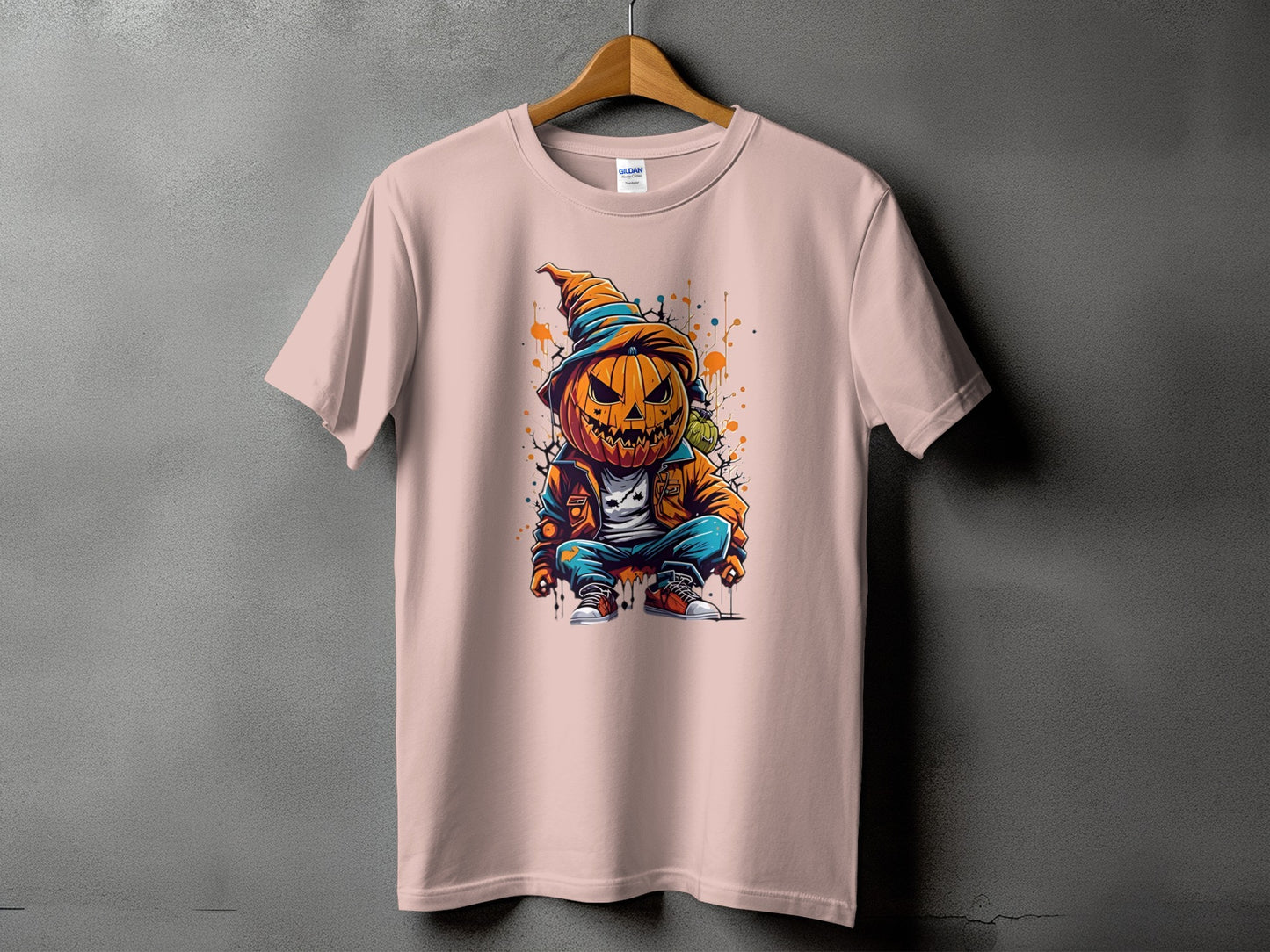 Pink t-shirt with a cartoon pumpkin character wearing a hat and jacket.