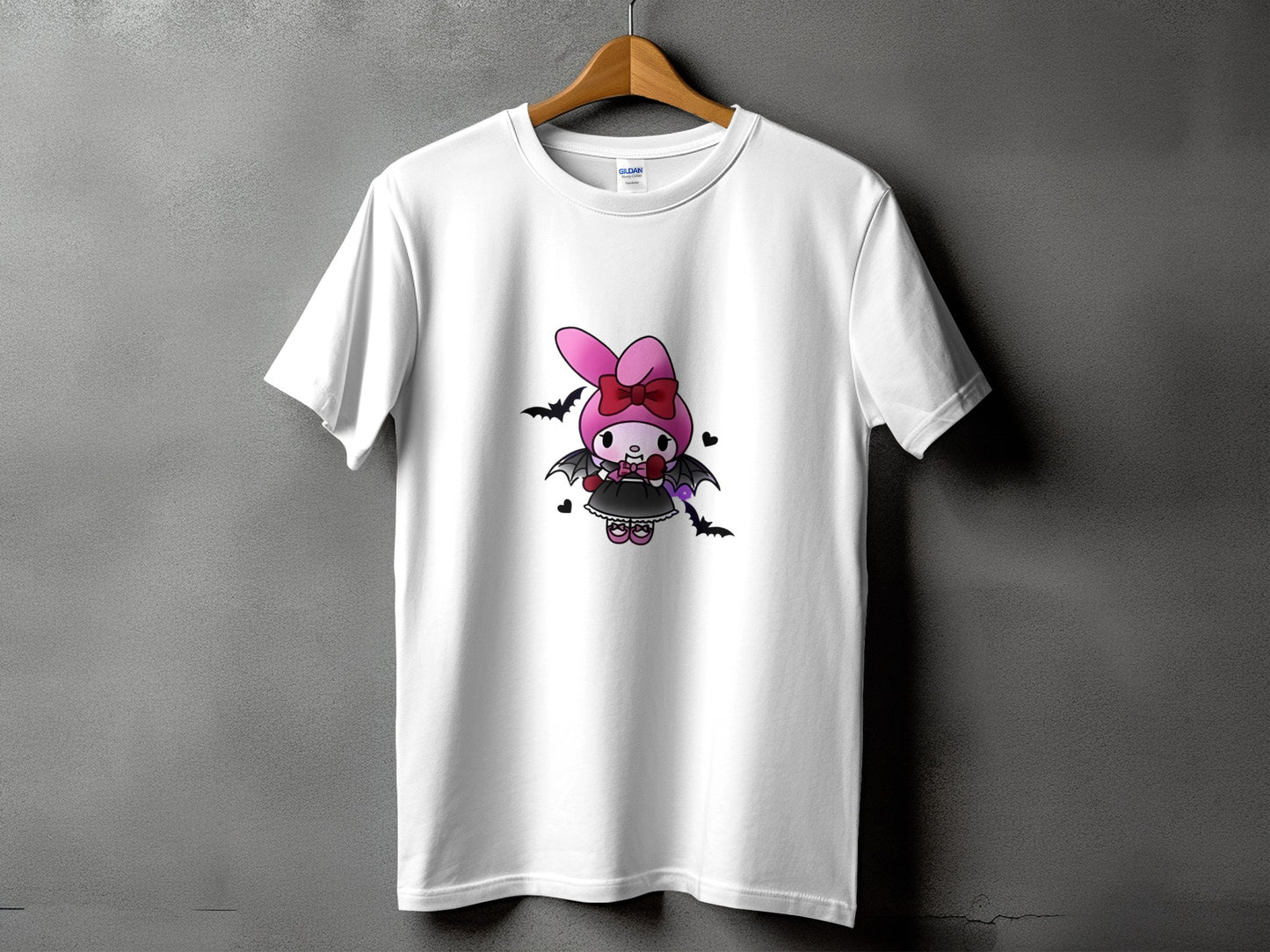 White t-shirt with cartoon character wearing a pink bow and bat wings.