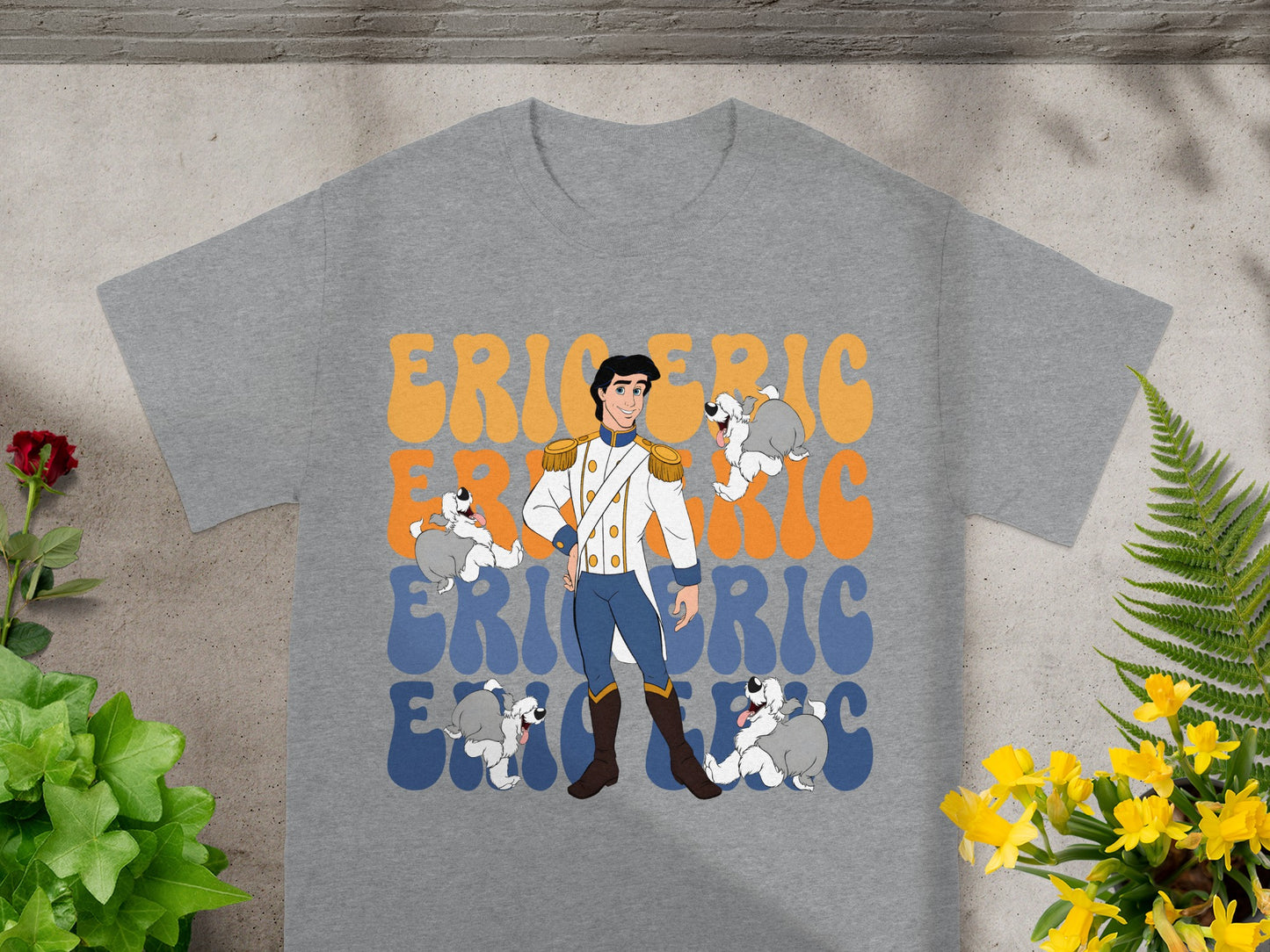 Prince Eric with four cartoon dogs on a grey t-shirt.