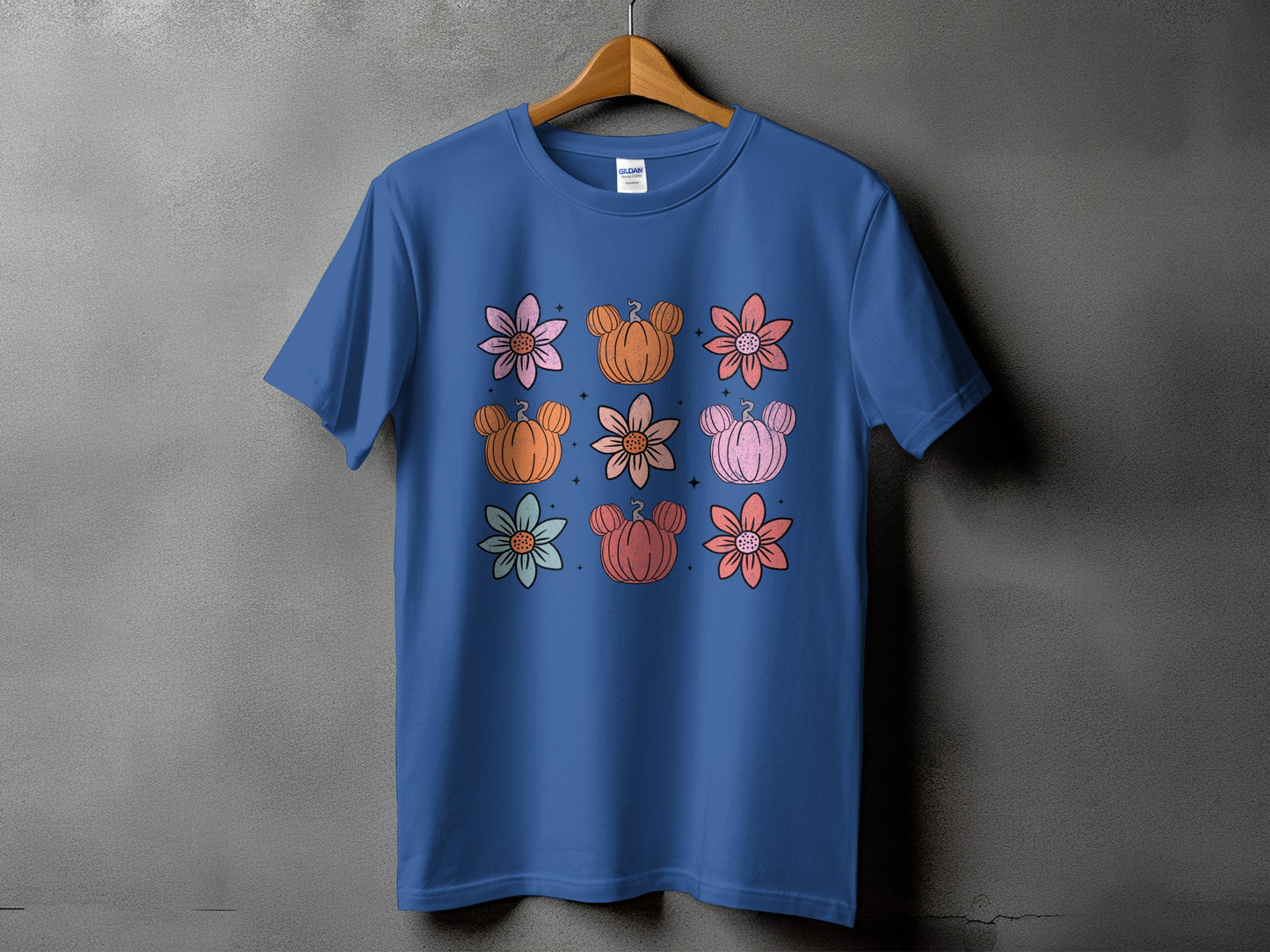 Blue t-shirt with a grid of stylized flowers and Mickey Mouse pumpkins.