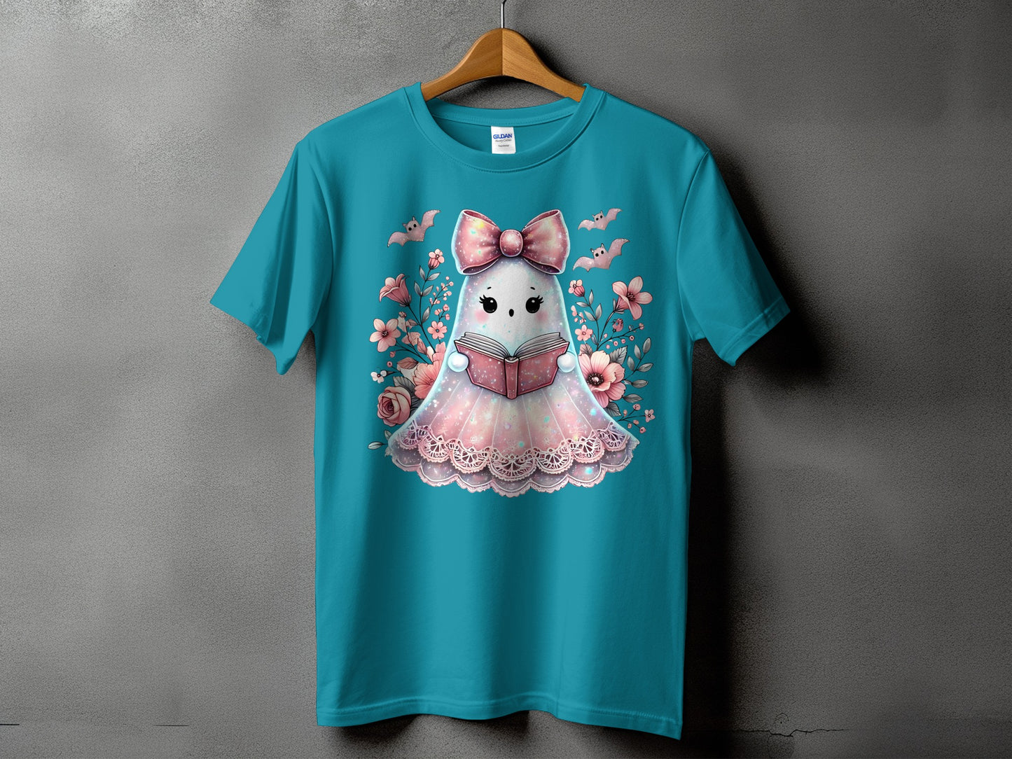 Ghost reading a book, surrounded by flowers and bats, on a teal t-shirt.