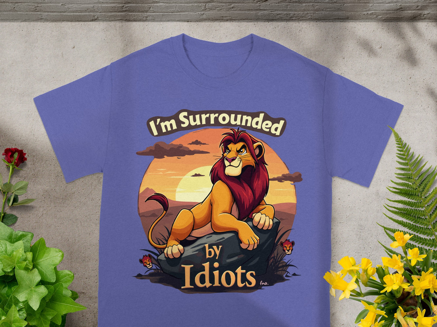 Purple t-shirt with a lion illustration and "I'm Surrounded by Idiots" text.