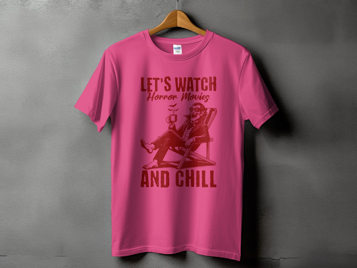 Pink t-shirt with "Let's Watch Horror Movies And Chill" text and vampire graphic.