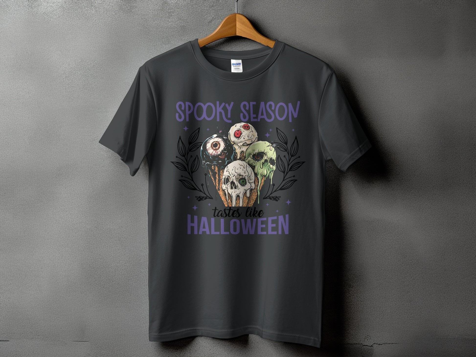Dark gray t-shirt with "Spooky Season Tastes Like Halloween" and spooky ice cream graphic.