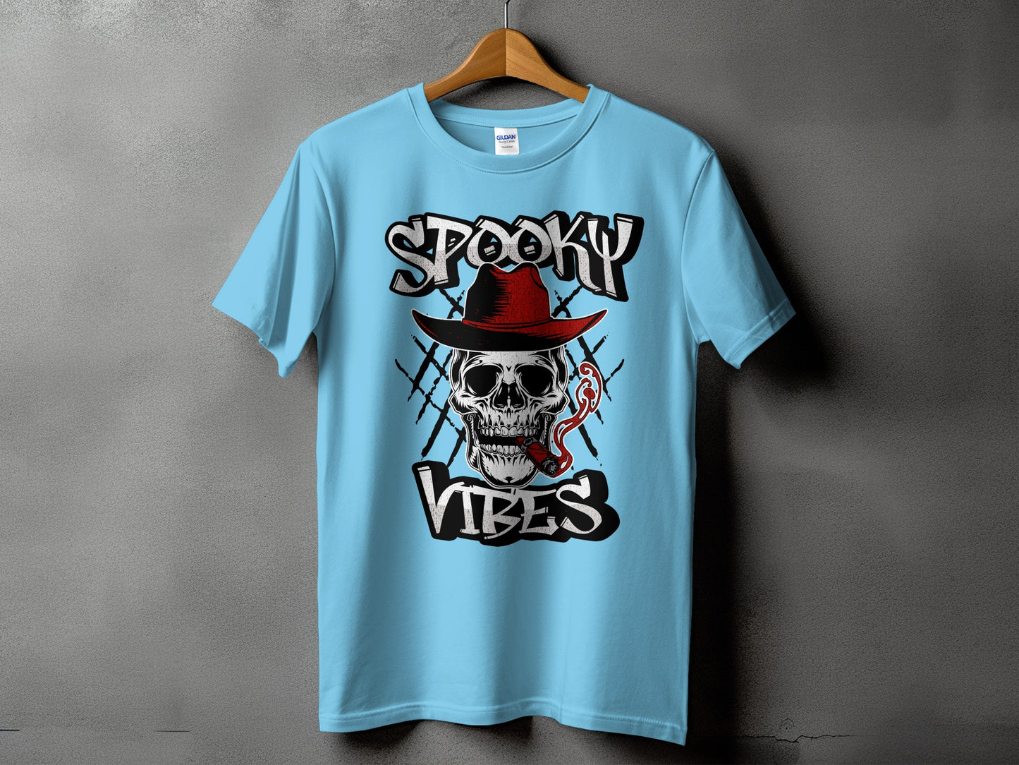 Light blue t-shirt with a skull wearing a hat, smoking a cigar, and text "Spooky Vibes."