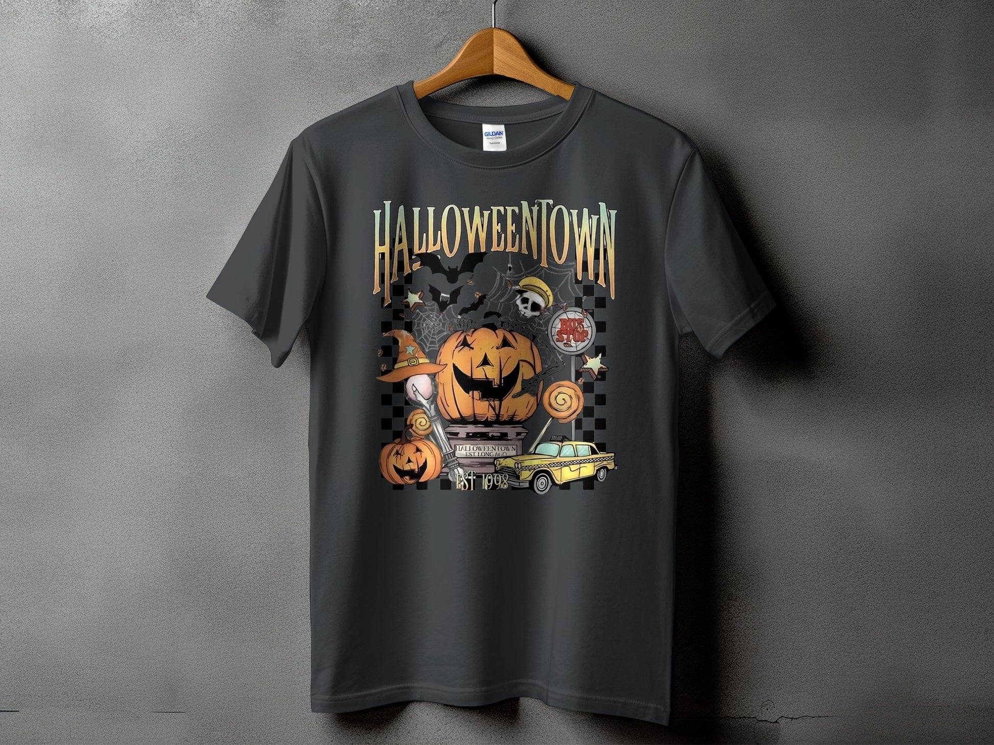 T-shirt with Halloweentown graphic featuring pumpkins, bats, a yellow taxi, and "EST 1998".