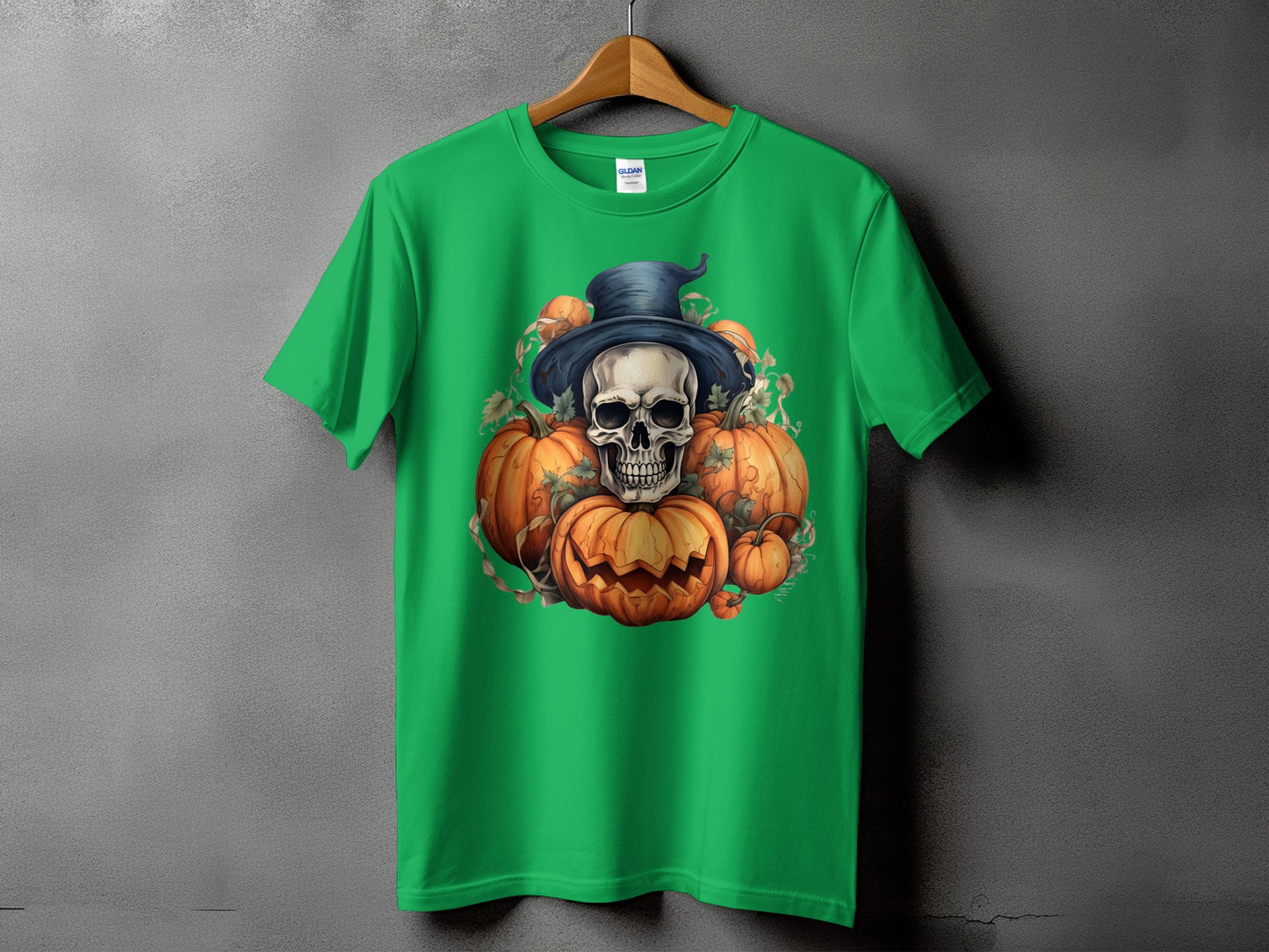 Green t-shirt with a Halloween design featuring a skull wearing a hat surrounded by pumpkins.