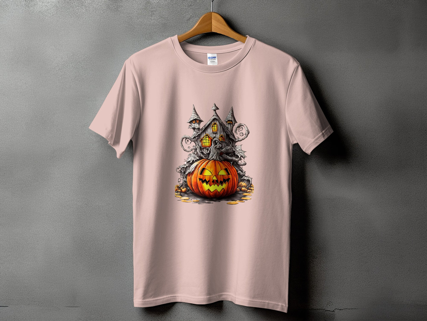 Pink t-shirt with Halloween graphic featuring a haunted house and jack-o'-lantern.