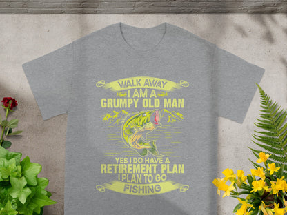 Grey t-shirt with yellow text and graphic of a fish saying "Walk away I am a grumpy old man. Retirement plan: fishing."