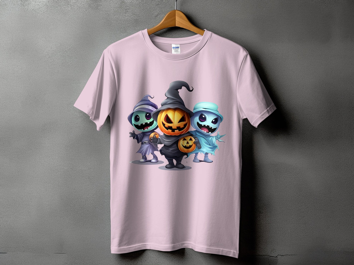 Pink t-shirt with cartoon Halloween characters: witch, pumpkin, and ghost.