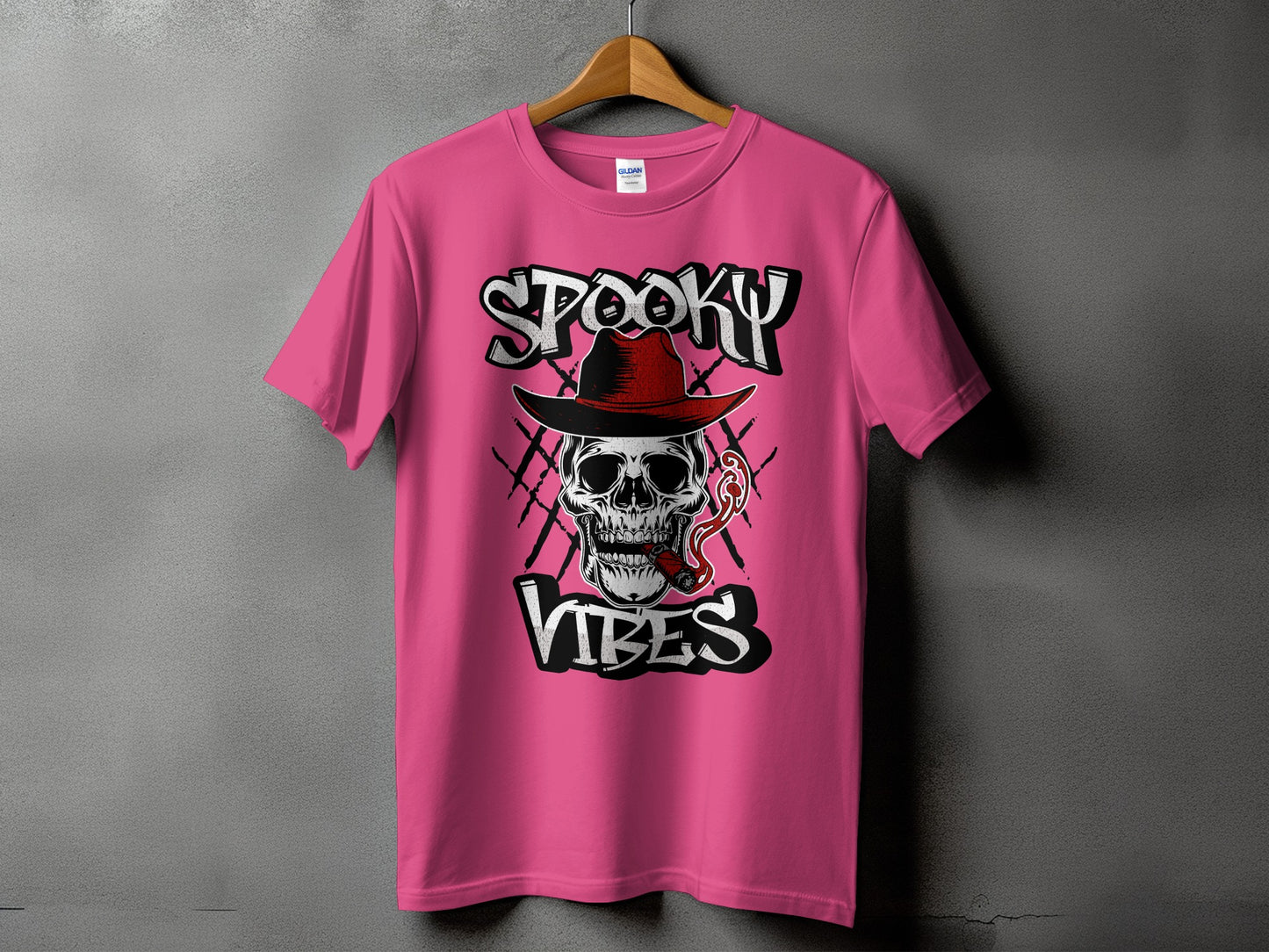 Pink t-shirt with "Spooky Vibes" graphic featuring a skull wearing a hat and smoking a cigar.