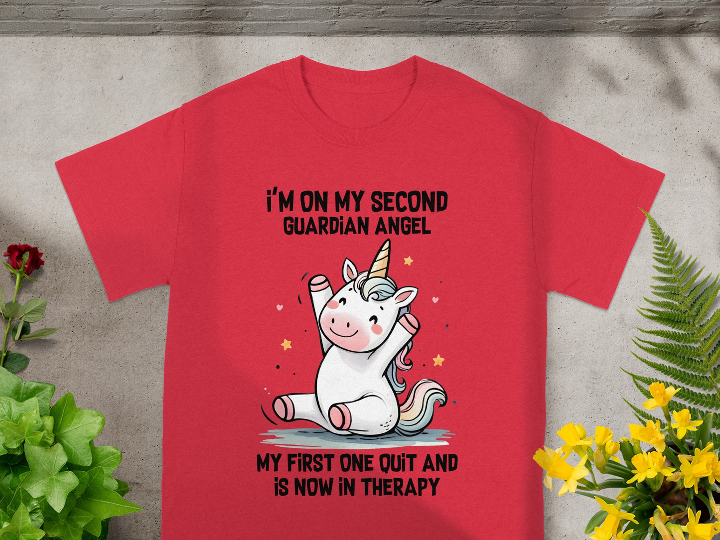 Red t-shirt with a cute unicorn and text: "I'm on my second guardian angel. My first one quit and is now in therapy."