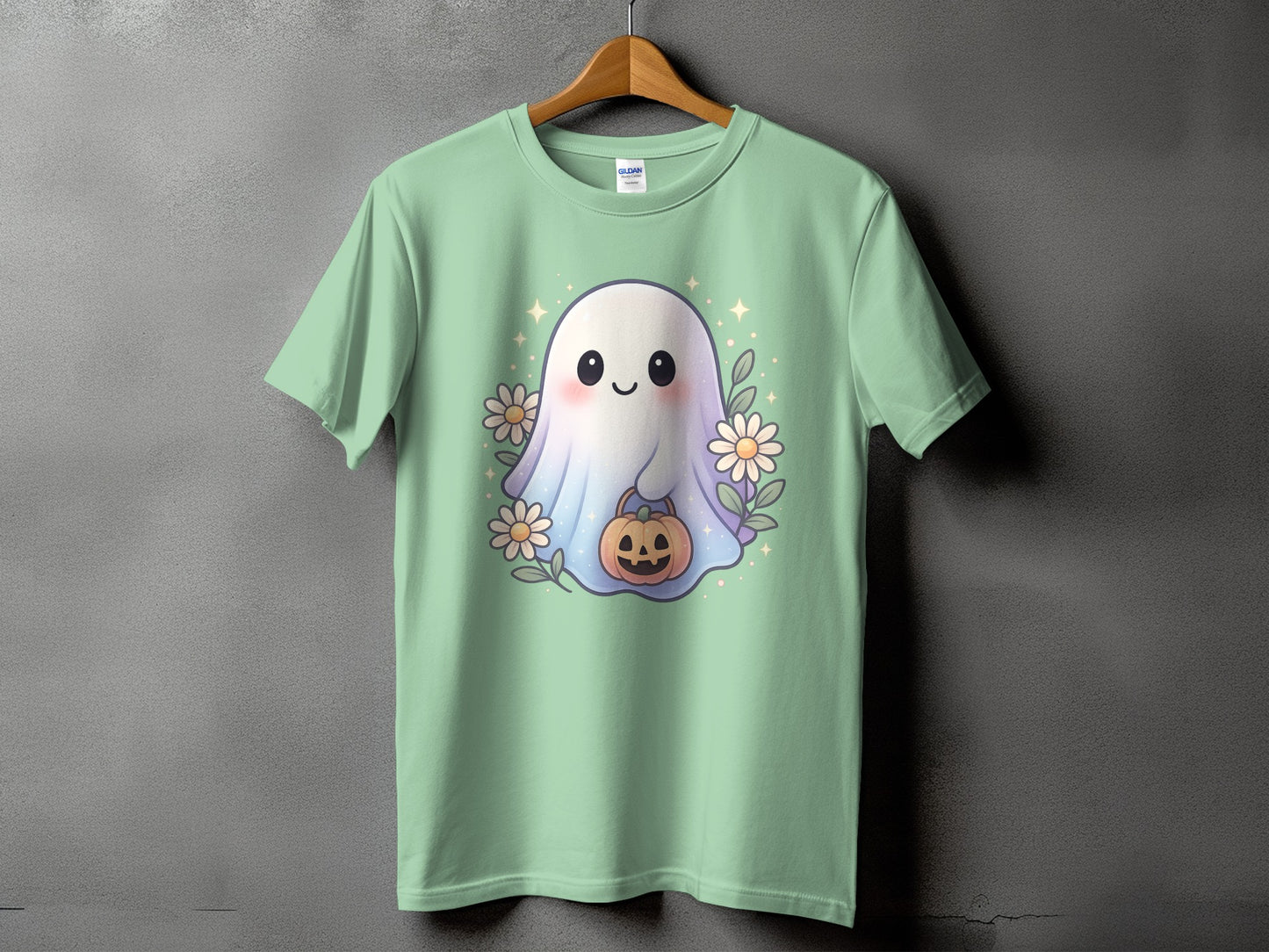 Cute ghost with pumpkin and flowers on a light green t-shirt.