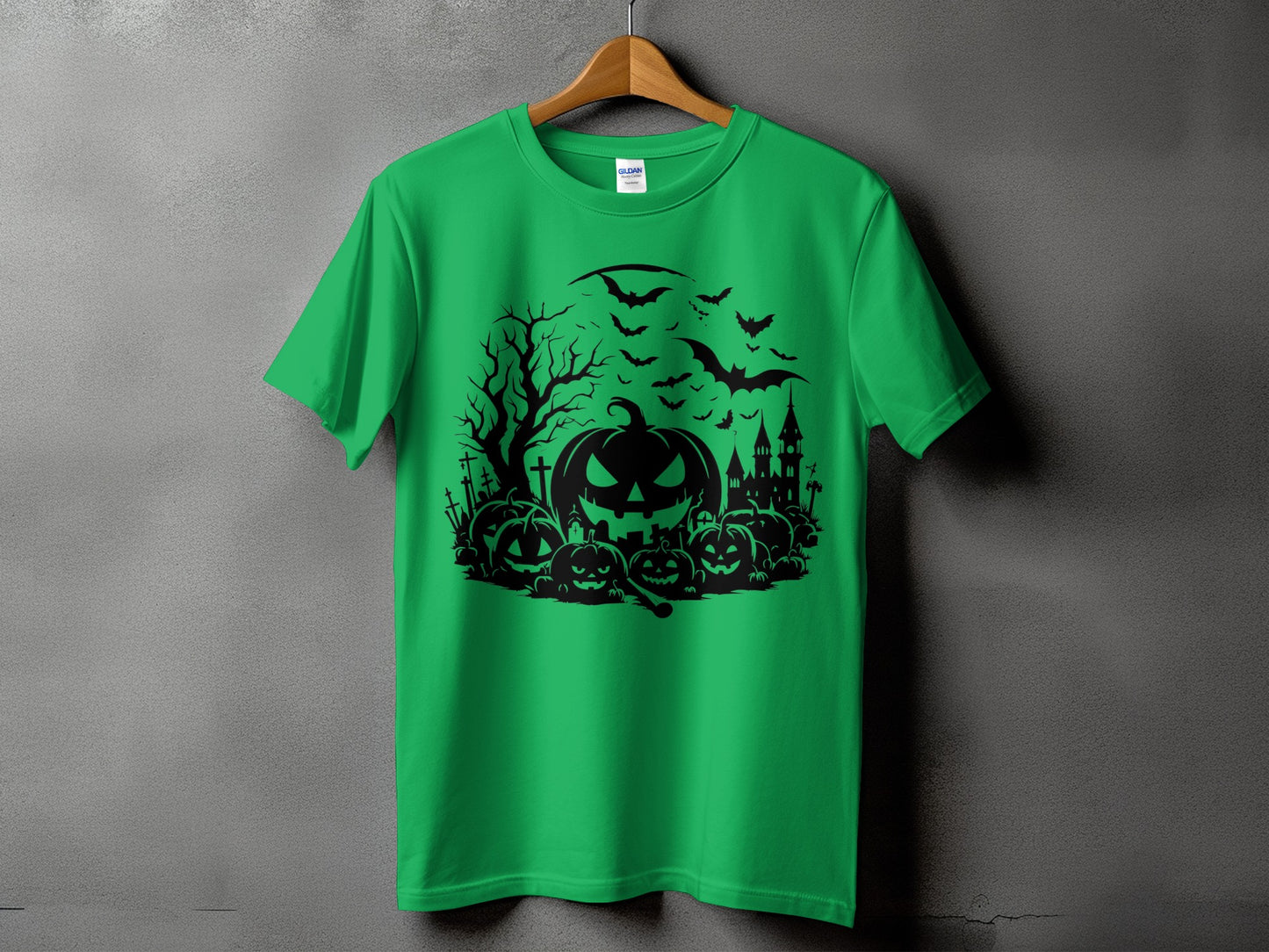 Green t-shirt with black Halloween graphic featuring pumpkins, bats, and a castle.