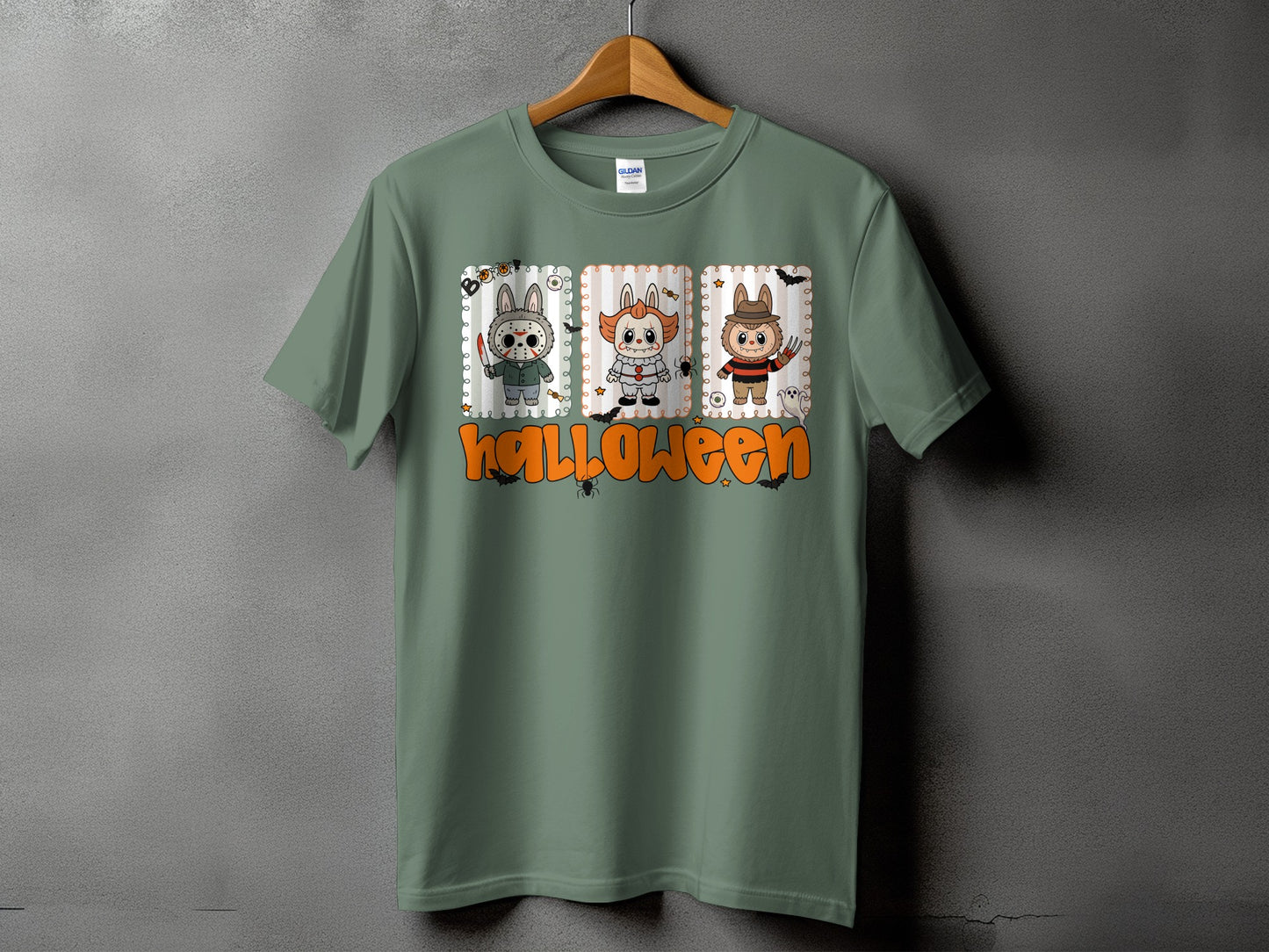 Green t-shirt with Halloween graphic of three horror characters and text.