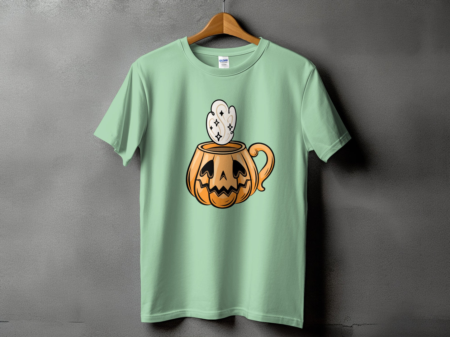 Light green t-shirt with a cartoon pumpkin mug graphic and steam.