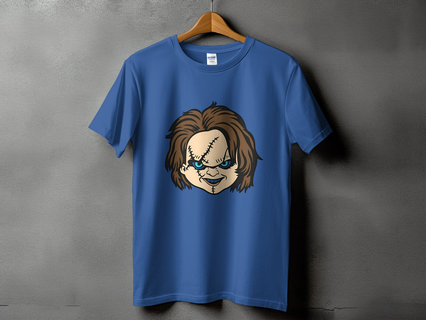 Blue t-shirt with Chucky doll face graphic and stitched details.