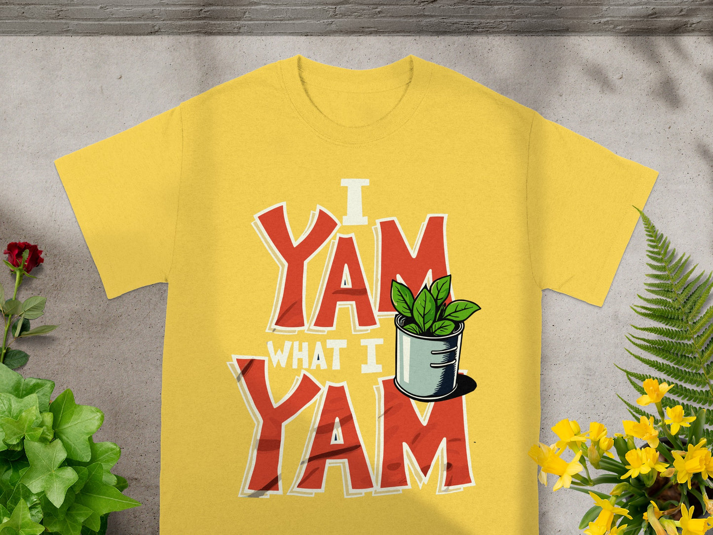 Yellow t-shirt with bold red "I YAM WHAT I YAM" text and green sprouts.