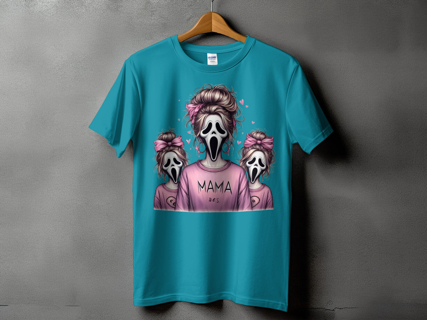 Teal t-shirt with "Mama Des" and Ghostface characters, some with pink bows.