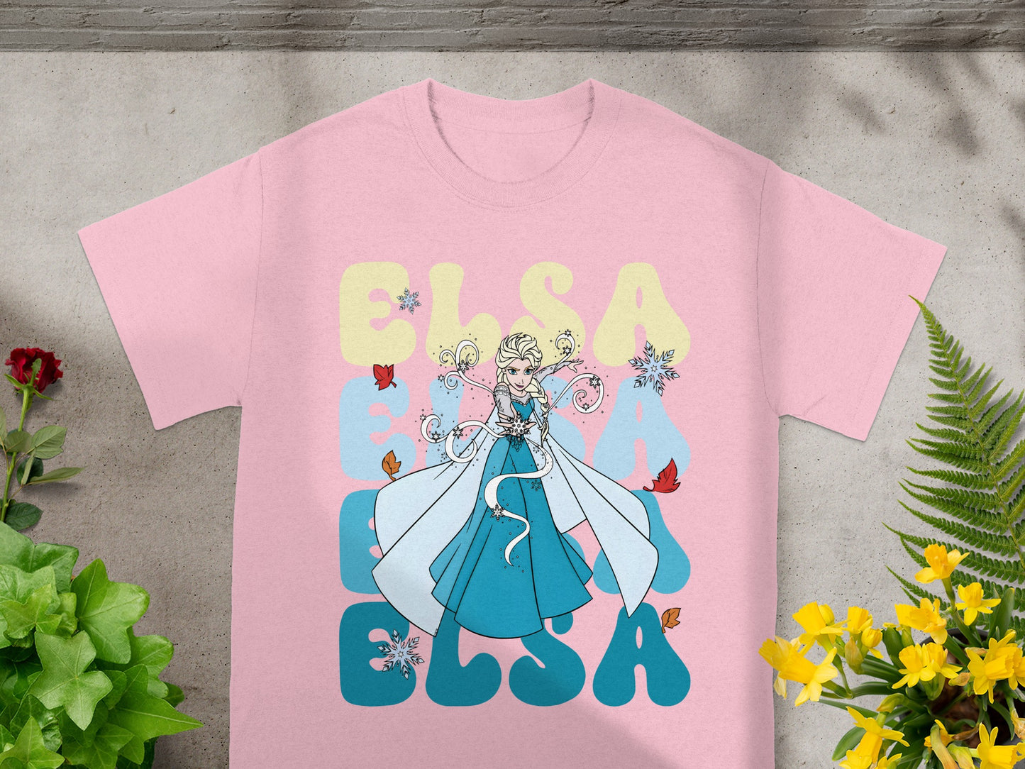 Pink t-shirt with Elsa from Frozen illustration and "ELSA" text.