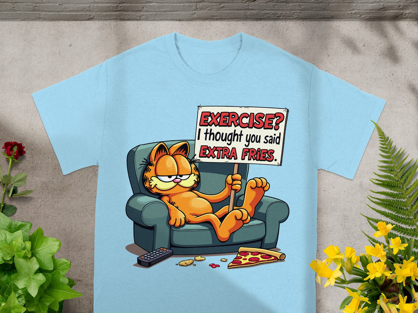 Light blue t-shirt with Garfield sitting on a couch holding a sign reading "EXERCISE? I thought you said EXTRA FRIES."
