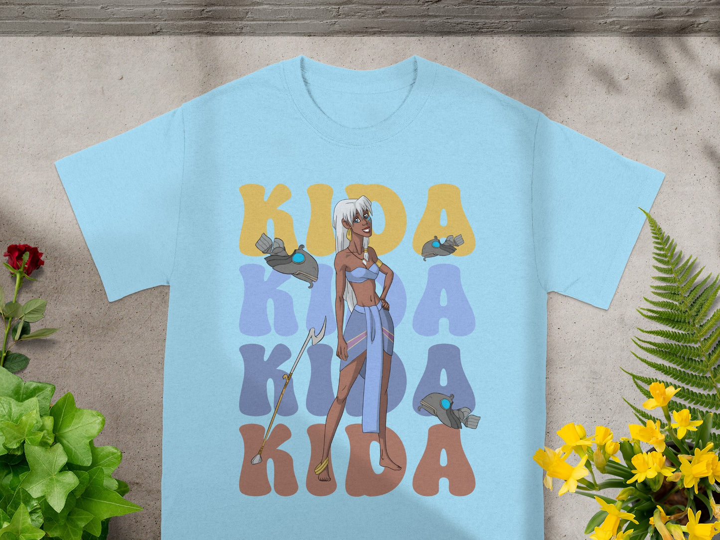 Light blue t-shirt with large "Kida" text and cartoon character Kida.
