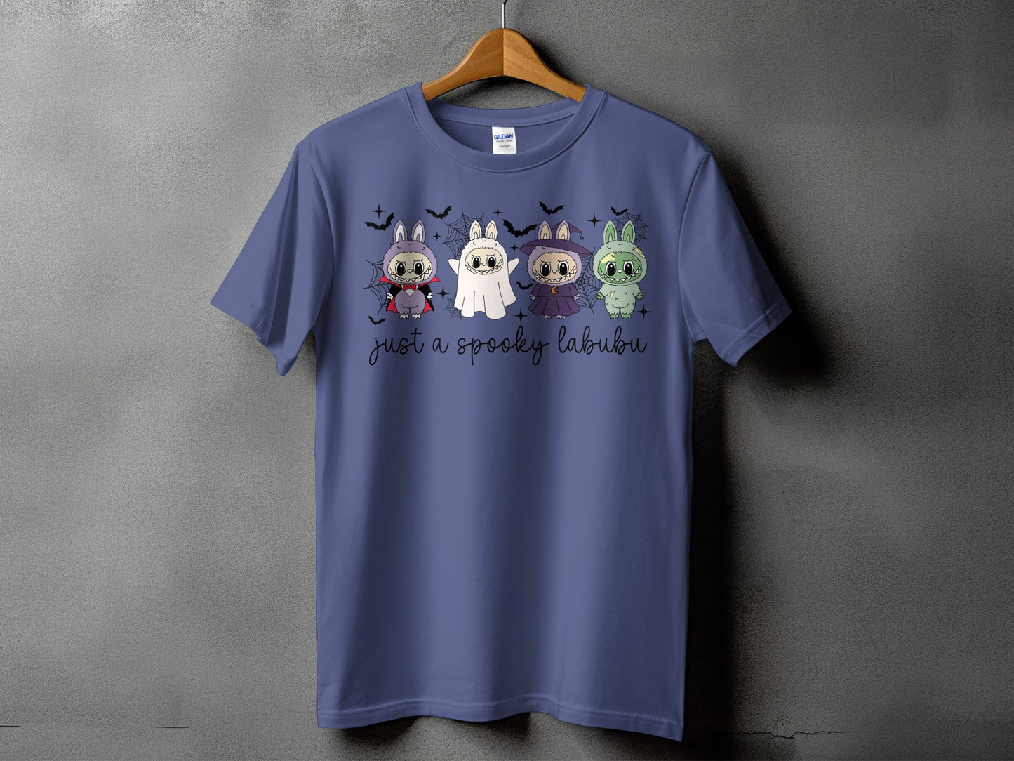 Purple t-shirt with four spooky cartoon characters and the text "just a spooky labubu."