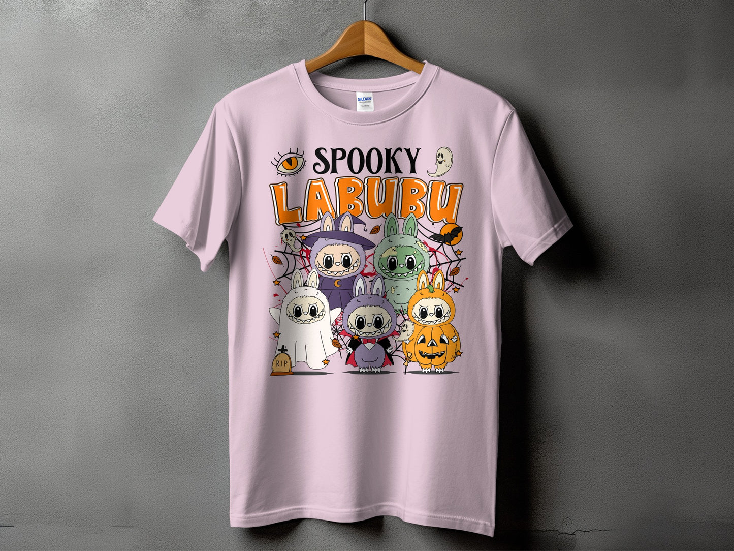 Spooky Labubu graphic on a pink t-shirt with Halloween characters.