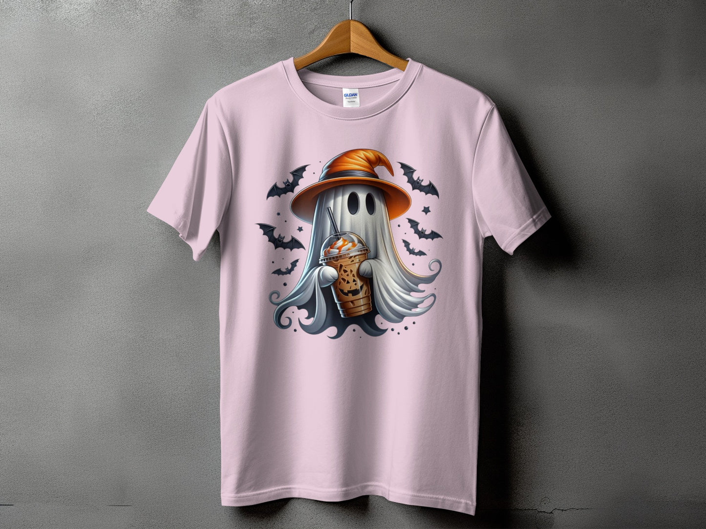 Pink t-shirt with a ghost in a witch hat holding a pumpkin spice latte.