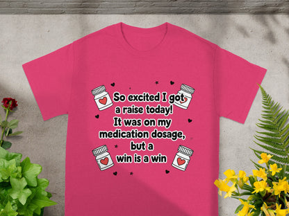 Pink t-shirt with text "So excited I got a raise today! It was on my medication dosage, but a win is a win."