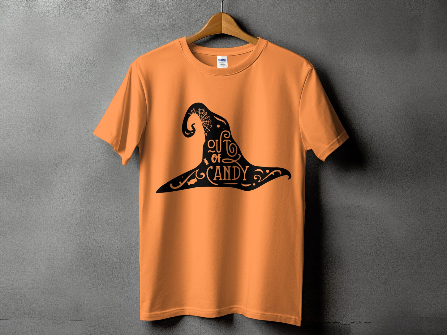 Orange t-shirt with black Halloween witch hat graphic that says "out of candy".