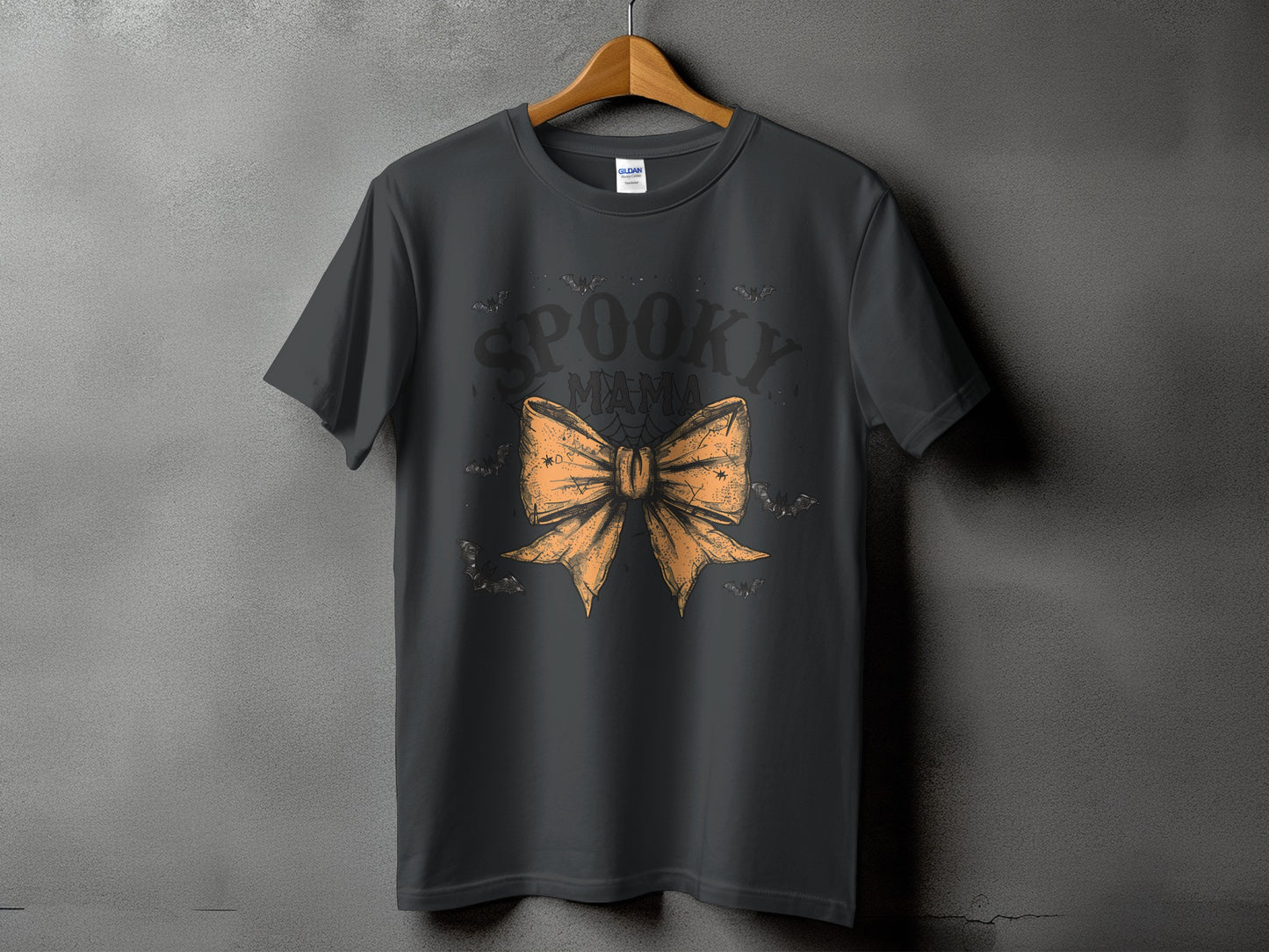 Dark gray t-shirt with "Spooky Mama" text and an orange bow graphic.