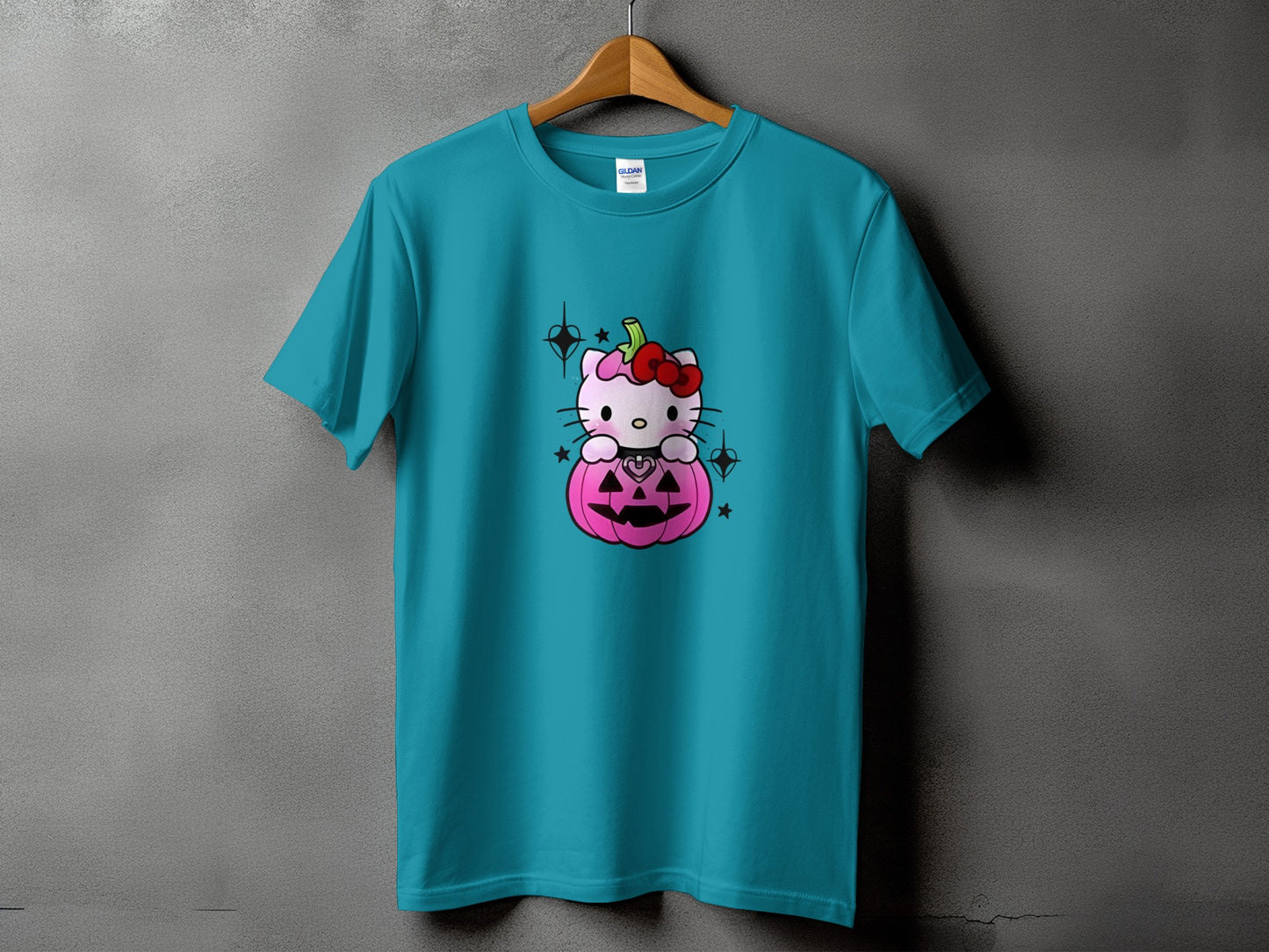 Teal t-shirt with Hello Kitty sitting inside a pink Halloween pumpkin.