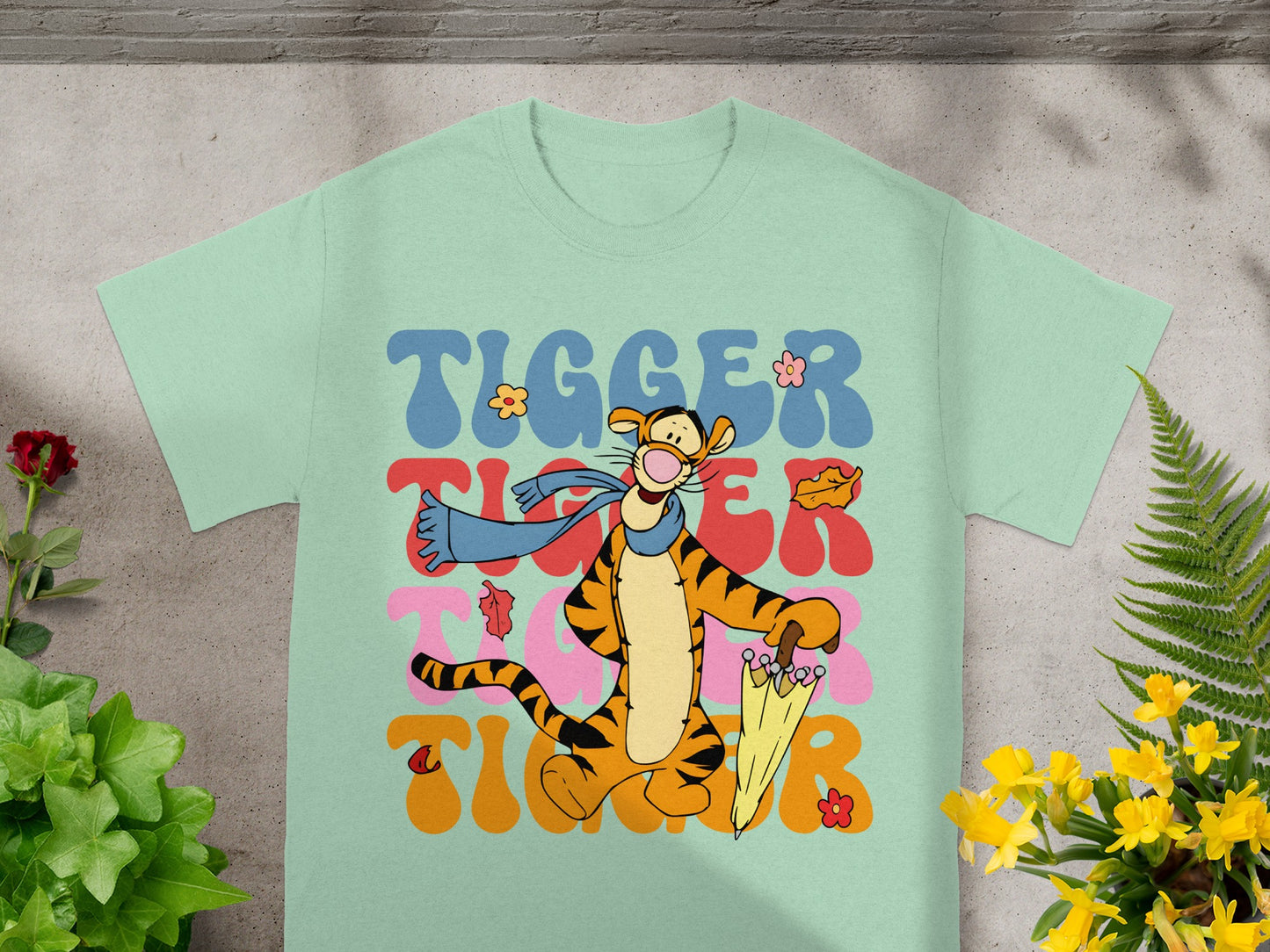 Tigger graphic tee with wavy text and yellow umbrella.