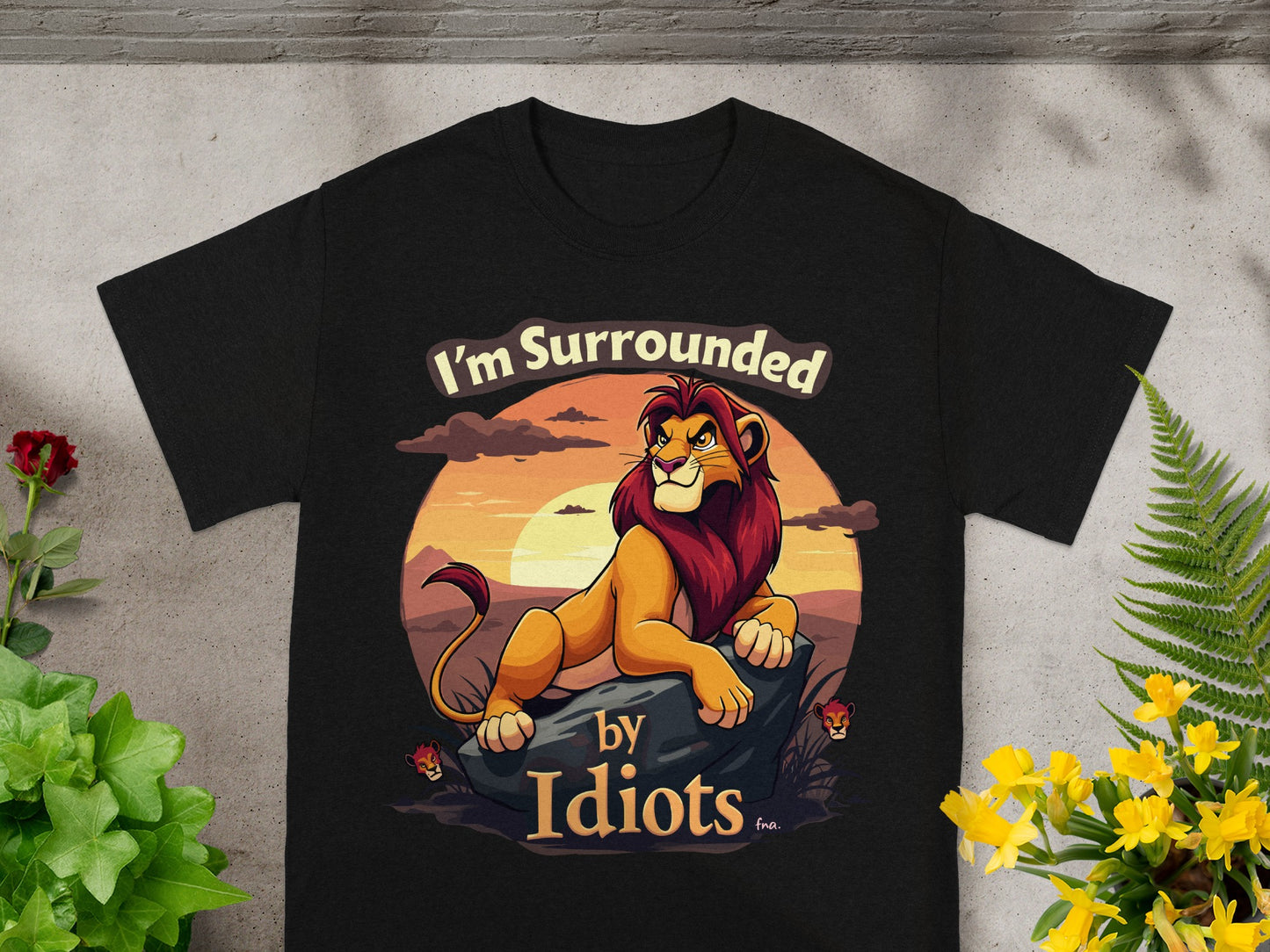 Black t-shirt with lion graphic and text "I'm Surrounded by Idiots".