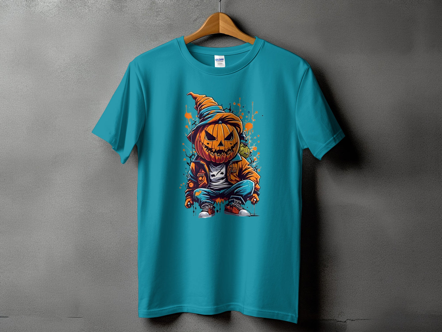 Teal t-shirt with a cartoon scarecrow pumpkin graphic.